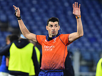 Referee Gauzere holds hands up...